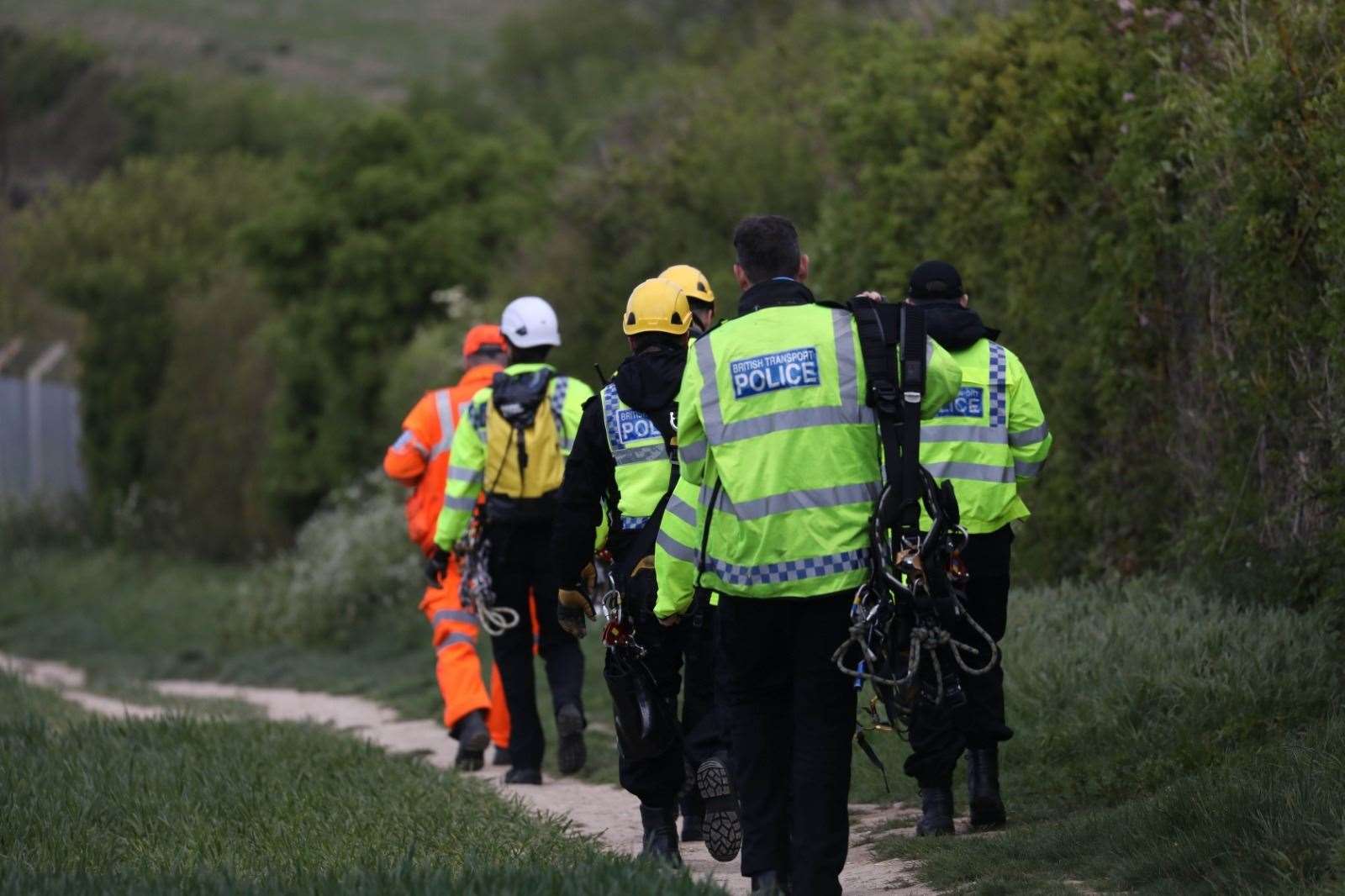 Police teams make their way to railway tracks in Aylesham Picture: UKNIP
