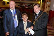 Steve Brown, from Sittingbourne a paralympian recieving deposit for a new wheelchair from the Mayor of Swale, cllr Alan Willicombe and Gary Croucher from the Isle of Sheppey Round Table.