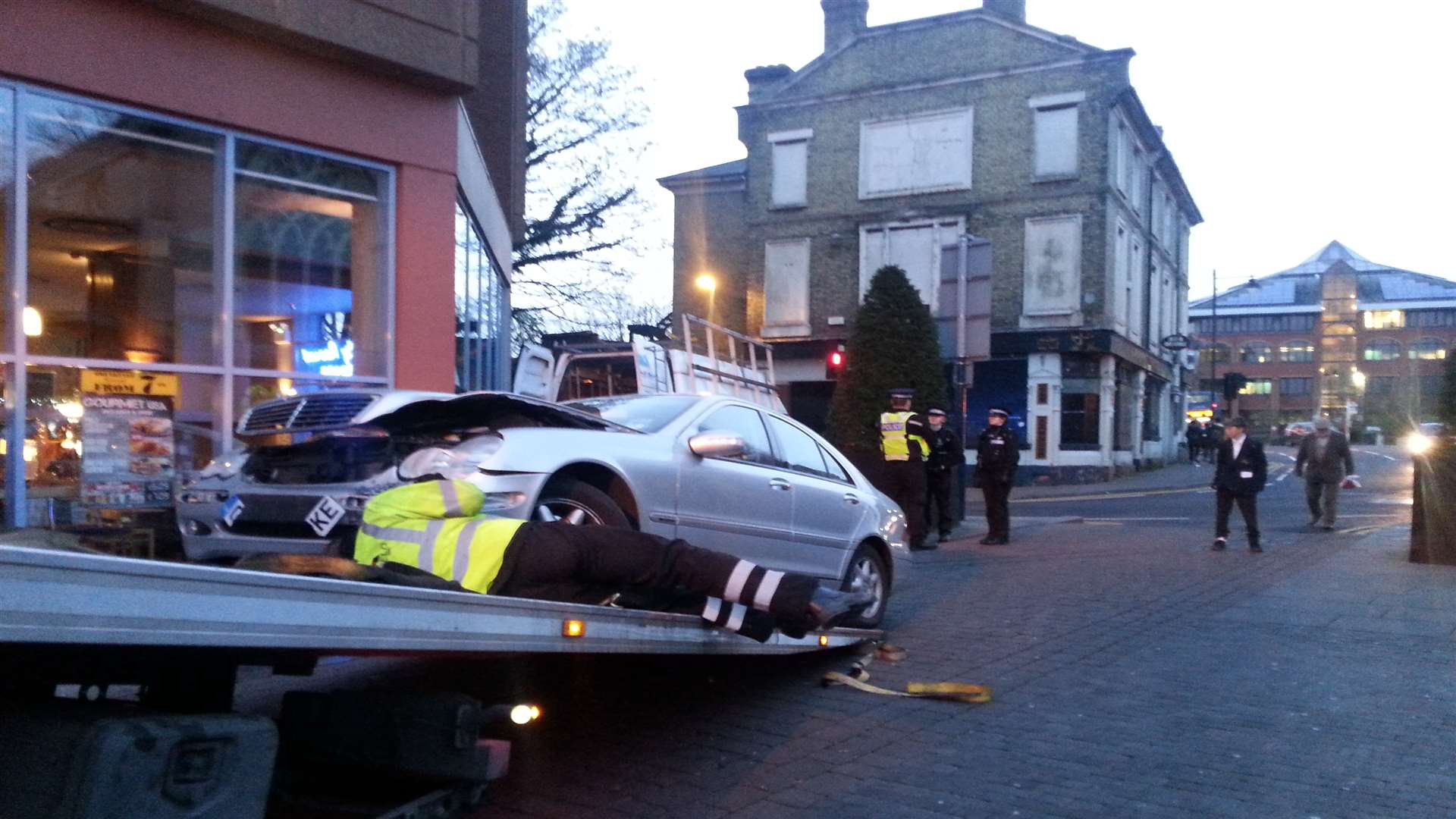 The damaged car is taken away