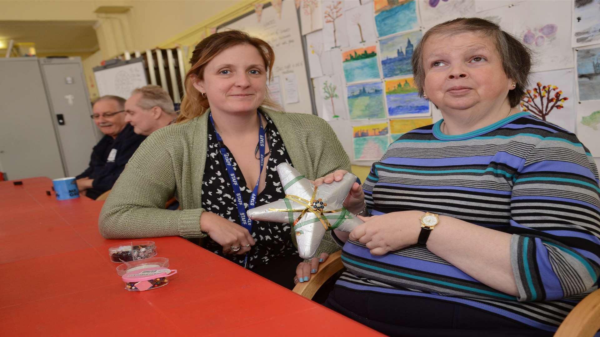 Assistant facilitator Nina Milton helping Sarah Walker with some craft-work. Picture: Gary Browne
