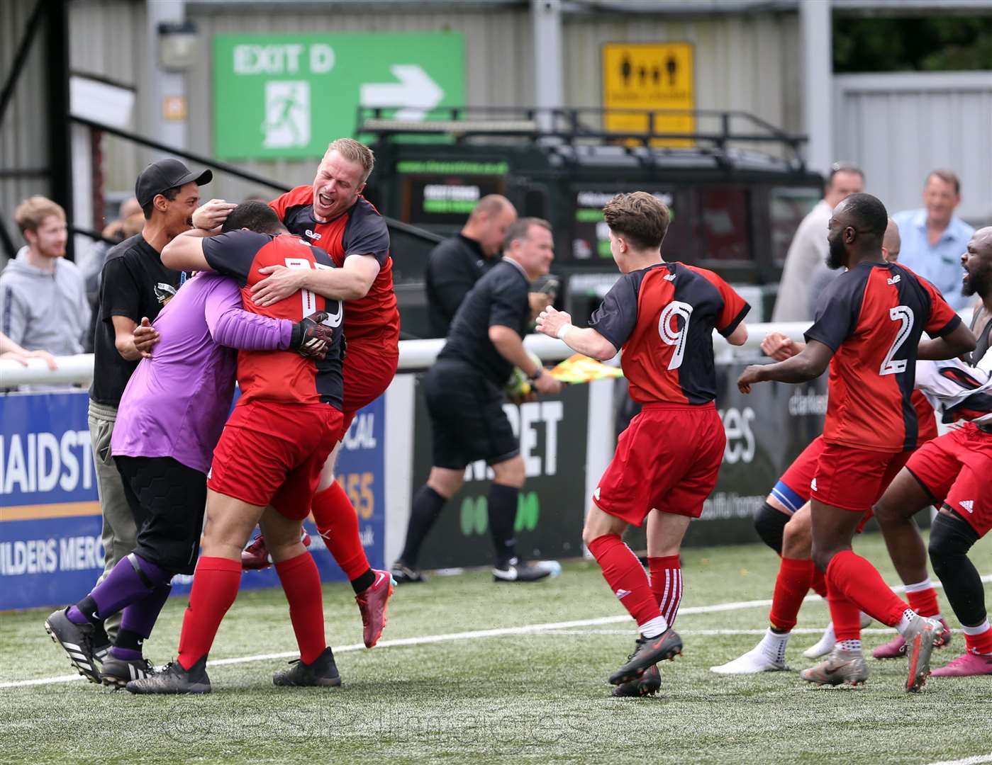Goalkeeper Mark Henderson is mobbed after Grand Sports Club's penalty shoot-out success Picture: PSP Images