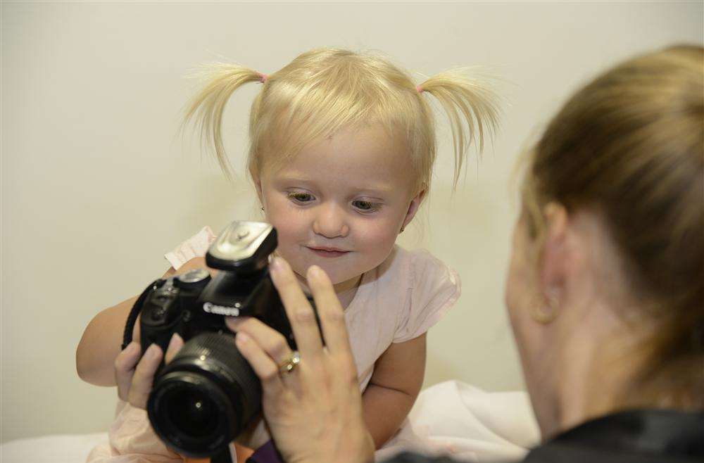 Gracie Ward having her picture taken by Stacey Wimbledon-Emig of Starlight Studios at Smyths toy store, Aylesford.