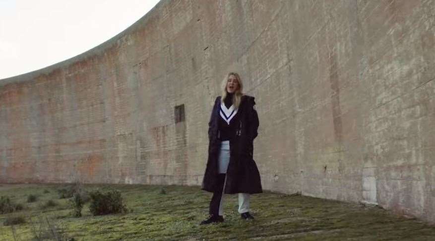 Singer Ellie is seen near the sound mirrors on the Marsh. Photo credit: River music video by Ellie Goulding