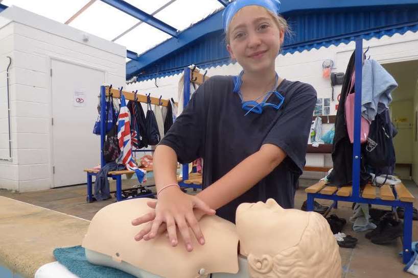 Year 6 pupil Katie, 11, performing compressions on the safety dummy Bob