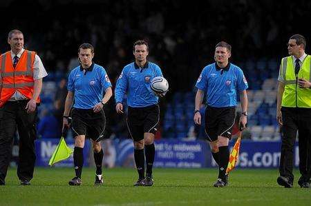 Referee Paul Tierney and his assistants leave the pitch to the jeers of the Priestfield crowd. Picture: Barry Goodwin
