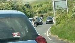 Vehicles are parked on a bend in the narrow country lane. Police-Dover twitter