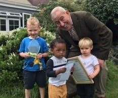 Gardening expert Jim Buttress presents youngsters at Muddy Puddles Childminders with their prize. Picture: Ruxley Manor Garden Centre