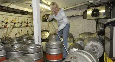 Pub landlady Sharon Dalton mops up. Picture: JOHN WARDLEY