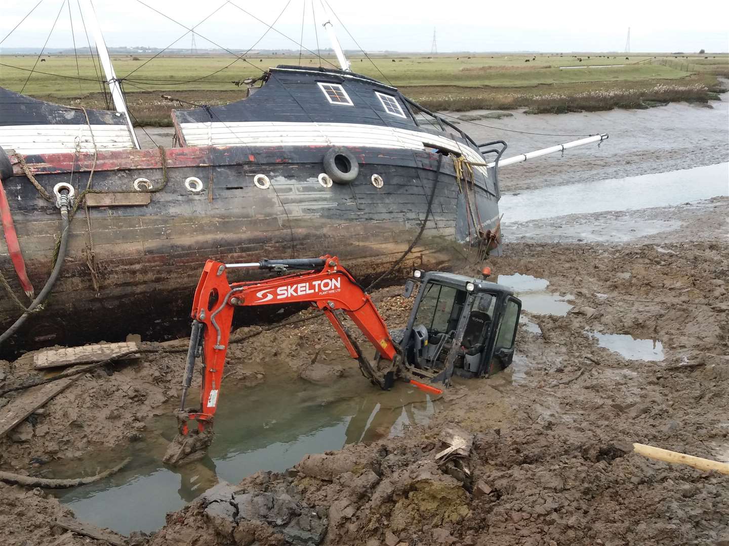 The digger brought in to rescue the Revenge from where it ran aground in Faversham Creek sunk into the mud
