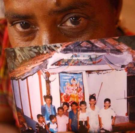 Katharyn's picture of 50-year-old Anna Lukshmi who lost her only daughter, Vithusa, to the tsunami in Sri Lanka. Anna is clutching a photo of the 10 year-old girl (second from right)