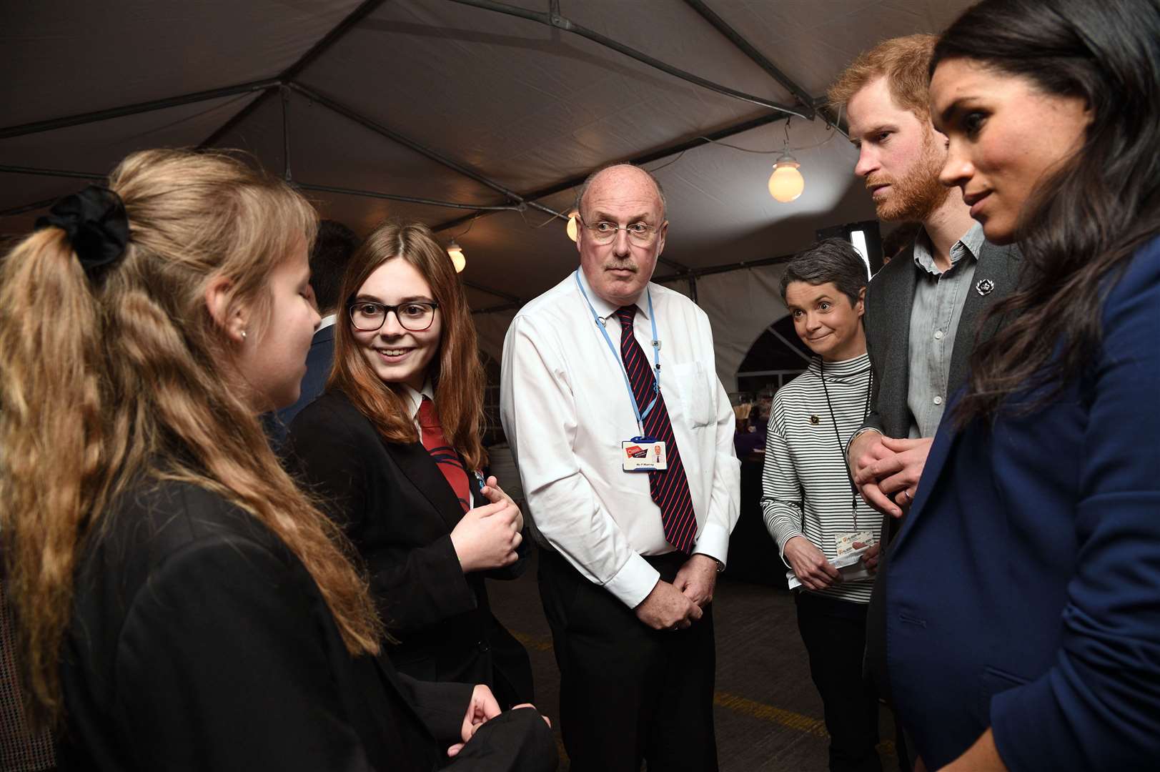 Oasis Isle of Sheppey Academy pupils Sinead Hubbard, 14, and Lucy Brightman-Stokes,12, meet the Duke and Duchess of Sussex Prince Harry and Meghan Markle backstage at Wembley Arena watched by teacher Paul Murray after the WE Day UK concert. Picture: Justin Goff/WE Day UK