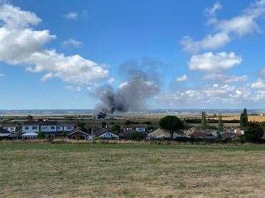Black smoke rises into the air from a caravan fire in Greyhound Road, Minster, Sheppey. Picture: Louise McLaren