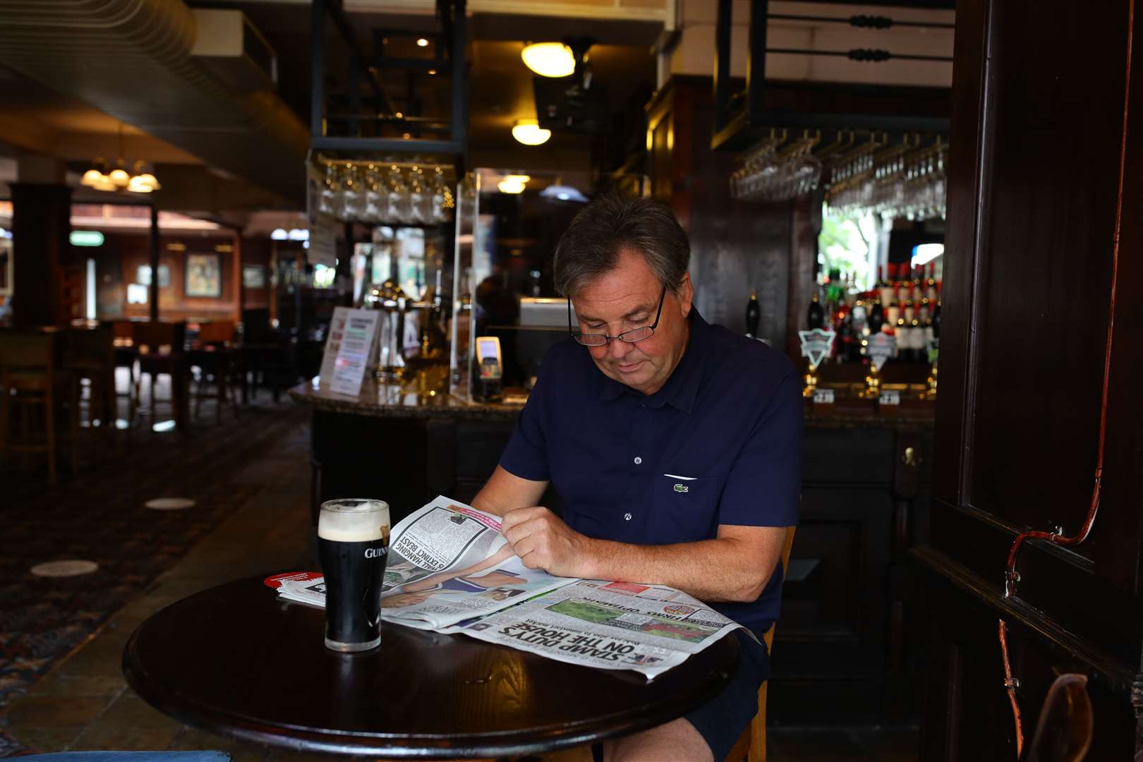 Andrew Slawinaki, 51, reading his paper while having a pint of Guinness at The Toll Gate (Aaron Chown/PA)