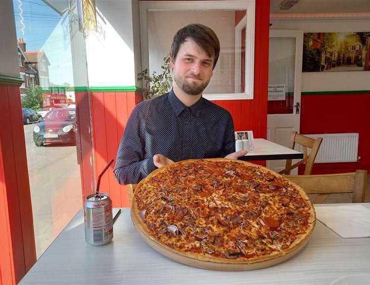 Reporter Brad Harper with the 20-inch pizza at Big Boys Pizza in Canterbury, which scored 23 out of 25
