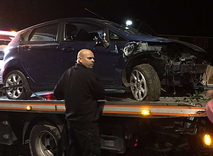 The damaged car is recovered from the scene. Picture: @Kent999s