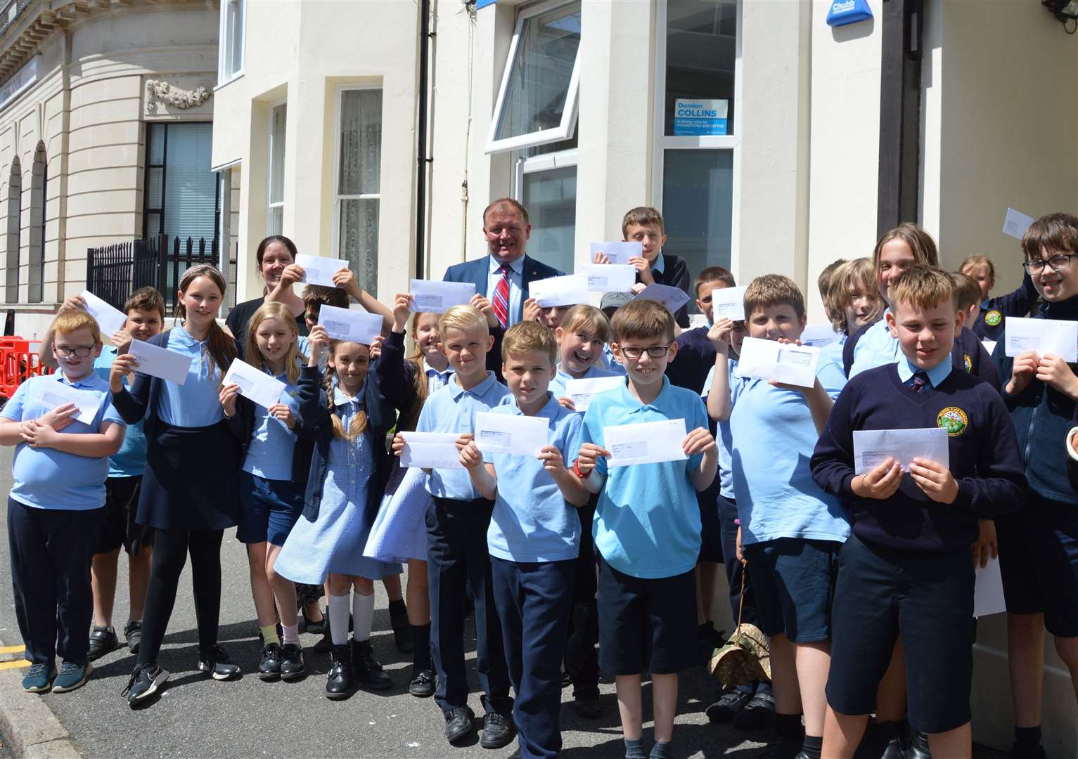 Pupils present letters calling for road safety measures to Damian Collins. Picture: Selsted Church of England Primary School