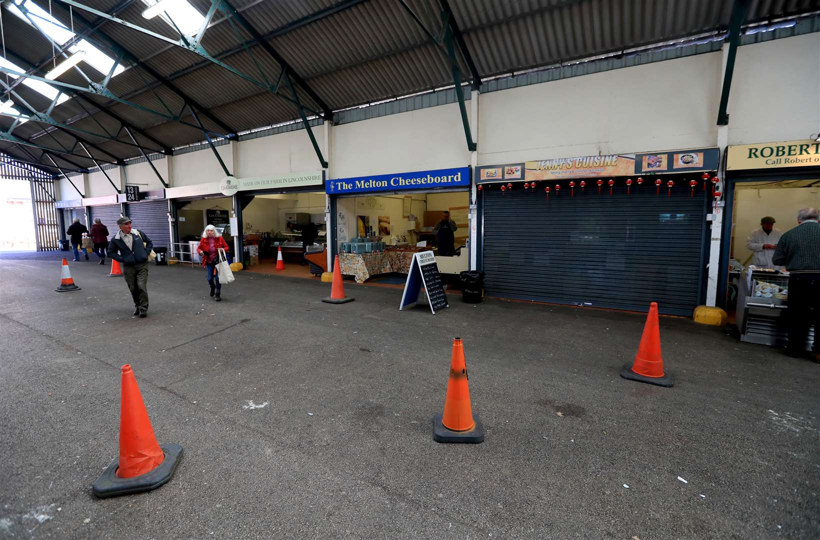 Shoppers walk around a mostly empty farmers market in Melton Mowbray, Leicestershire (Mike Egerton/PA)