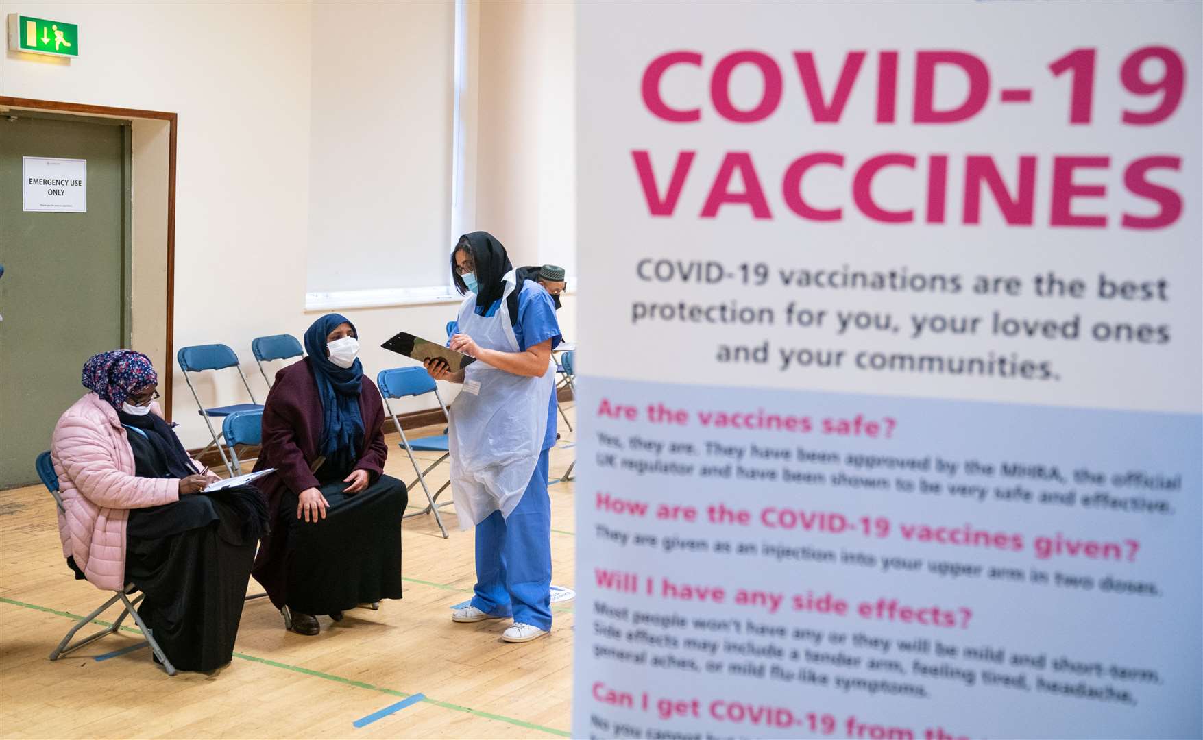 People attend a pop-up Covid-19 vaccination centre at the East London Mosque (Dominic Lipinski/PA)