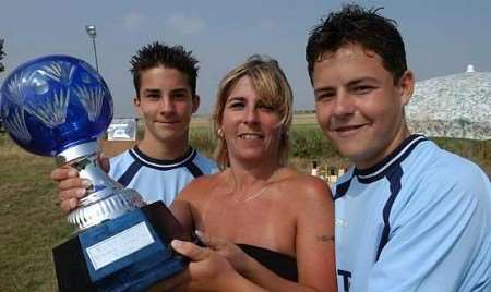 TOGETHERNESS: Maria Abbott, with sons Aaron and James, with the Richard Abbott trophy. Picture: MIKE SMITH