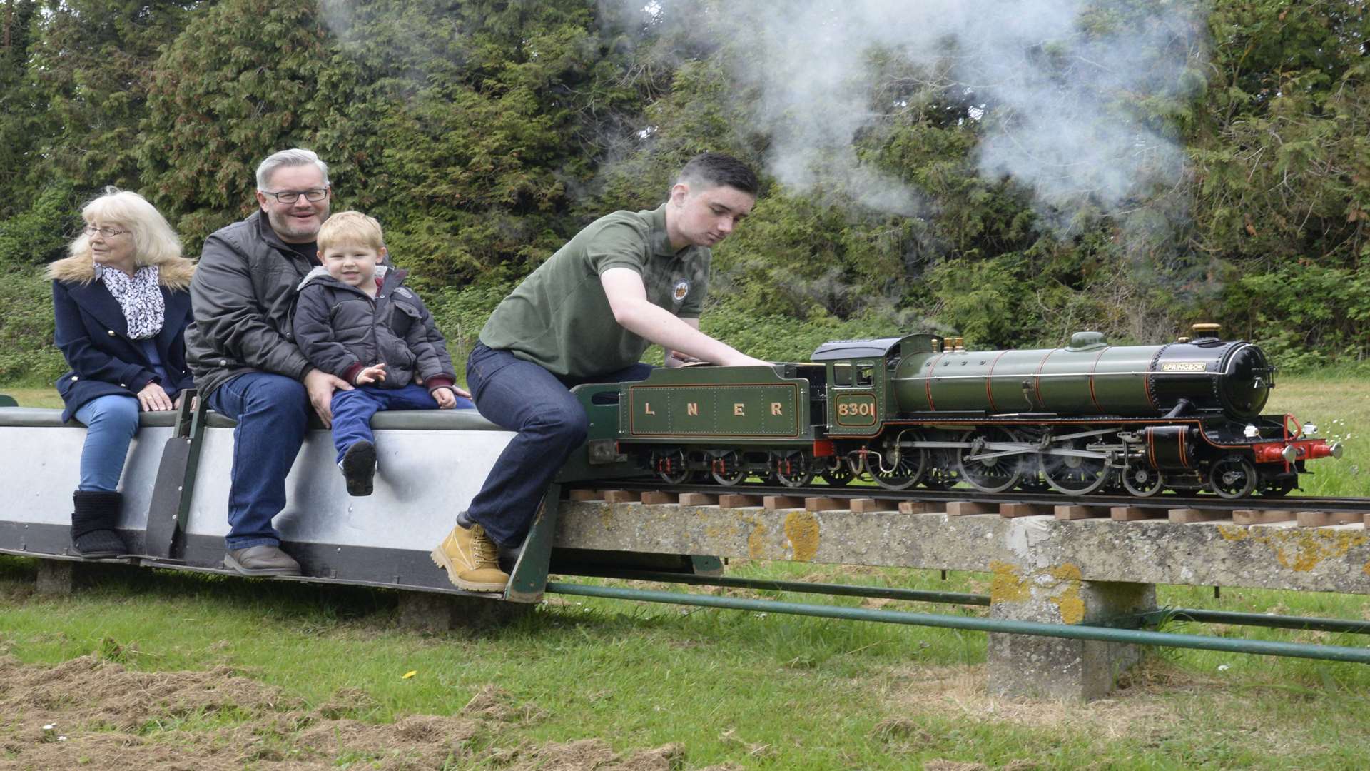 Charlie Guy takes some passengers for a trip on one of the test trains prior to the re-opening of the track.