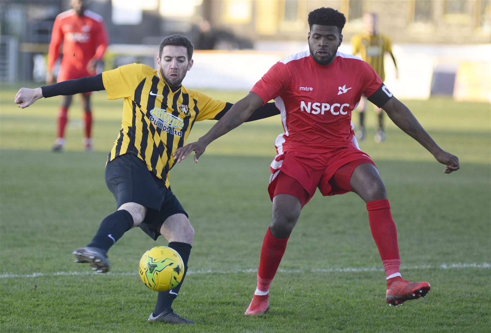 Folkestone (left) get stuck in during Saturday's 3-1 defeat to Carshalton .Picture: Paul Amos