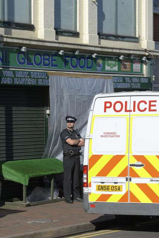 Police outside the Luton shop where Harjit Chaggar's body was found
