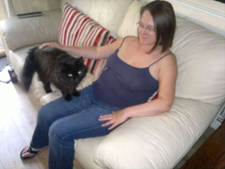 Emily with her beloved cat Scrumpy when he first began living with her