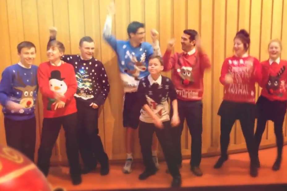 Staff and pupils enjoying making the video of them all in their favourite Christmas jumpers