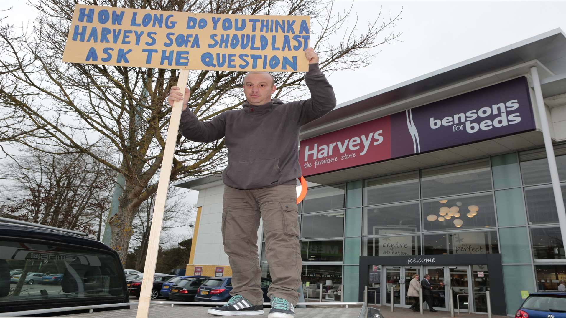 Ian Hayden, 44, from Paddock Wood, stages a protest outside Harverys after receiving bad customer service from the company