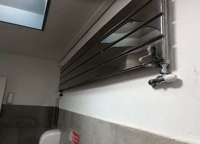 Completing the stainless steel décor in the gents this polished radiator is positioned high up on the toilet wall