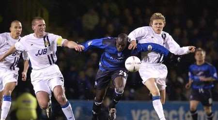 OVERWHELMED: Gillingham's Mamady Sidibe has a tough time among the Wigan defenders at Priestfield last night. Picture: MATT WALKER