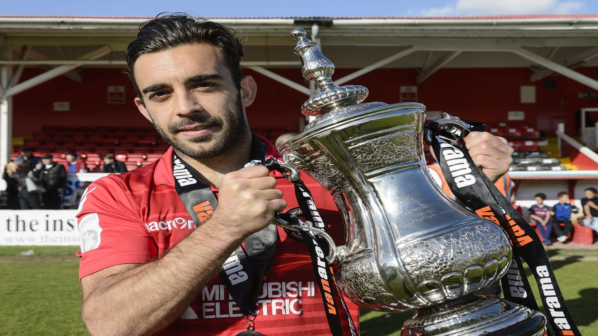 Sam Deering with the National League South play-off trophy Picture: Andy Payton