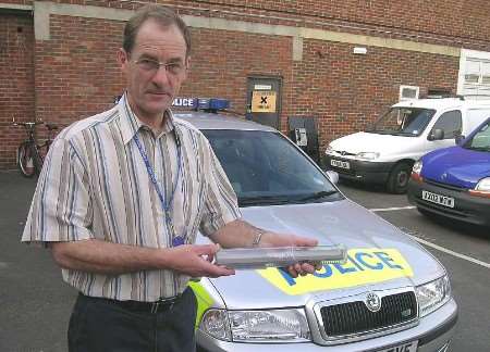 Det Con Keith Fraiser holding the pin hole camera device at Sittingbourne Police Station