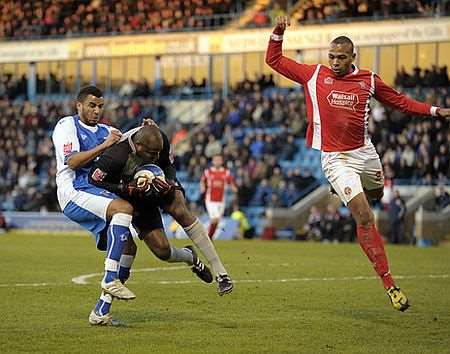 Gillingham's Rene Howe is beaten to the ball by Walsall keeper Clayton Ince. Picture: Barry Goodwin
