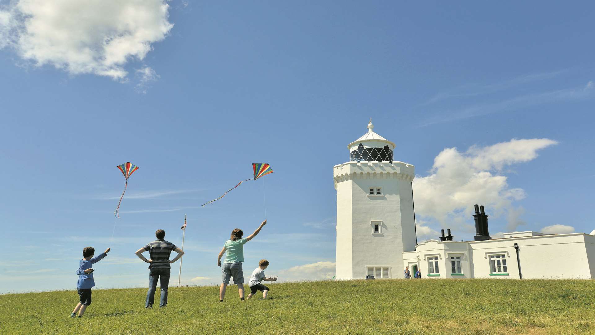 Family visitors flying kites by the South Foreland Lighthouse, Kent, on a sunny day. Picture: NTPL Commissioned (NTPL) ©National Trust Images/Solent News and Photography Agency