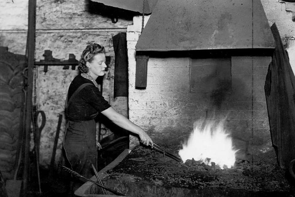 A woman blacksmith working at the Railway Works