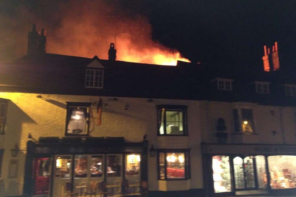 Flames erupt from the shop in Tenterden High Street. Picture: @EdHoad