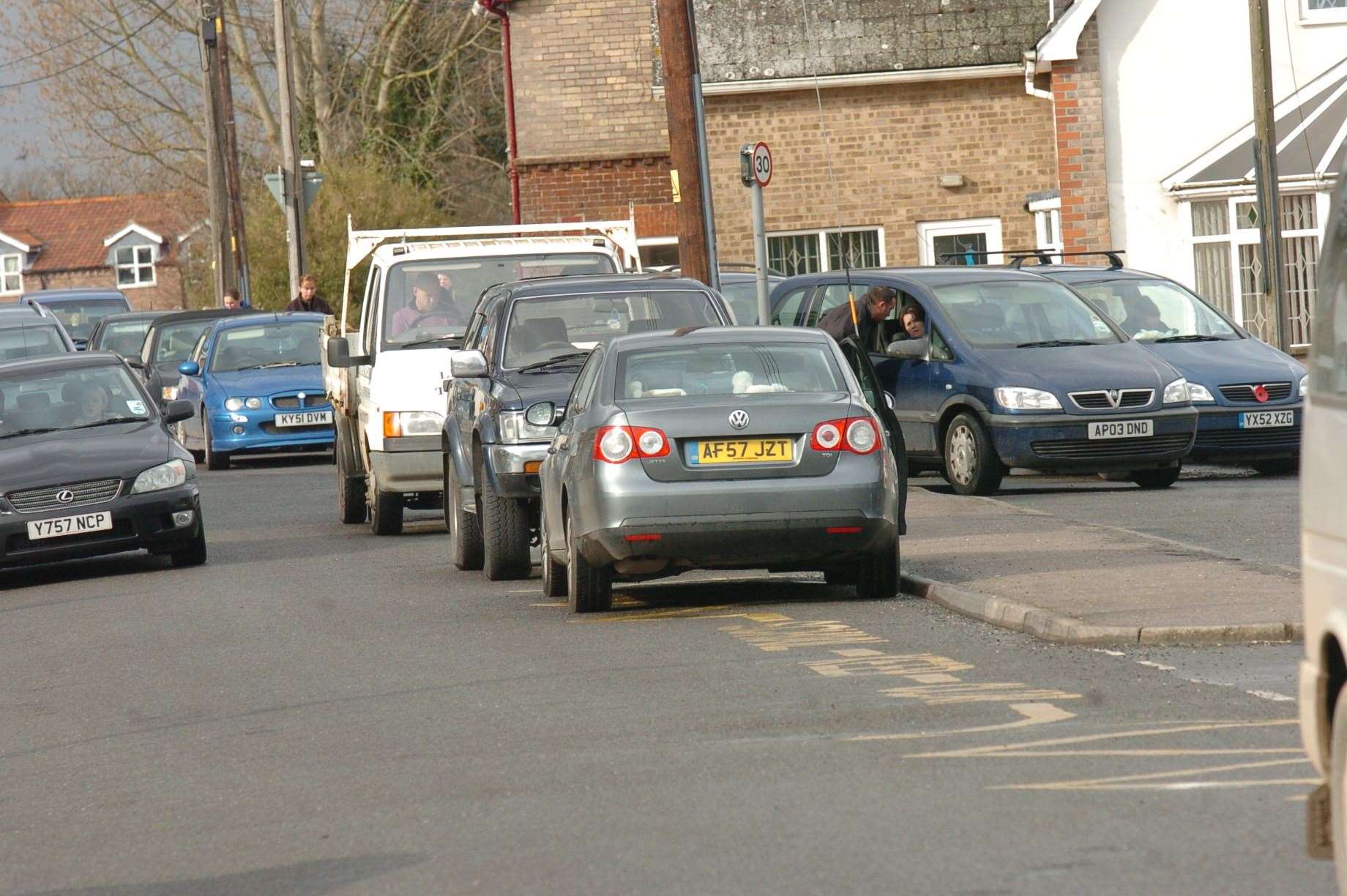 Parents parking outside a school and pre-school on zig zag lines. (stock pictures)