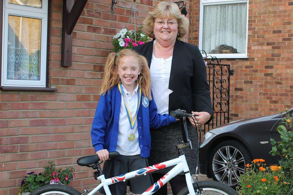Fiona Trigwell presents eight-year-old Millie Mackay, from Minster, with her bike