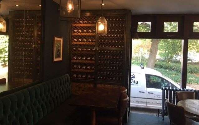 Subtle lighting and some clever stacked storage of wine bottles creates the feel of an old-fashioned snug in this smaller area above the main bar