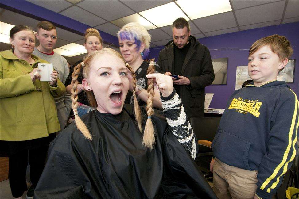 One plait down, three to go for Kirsten Johnson, who had her head shaved to raise money for Ezmae Catley