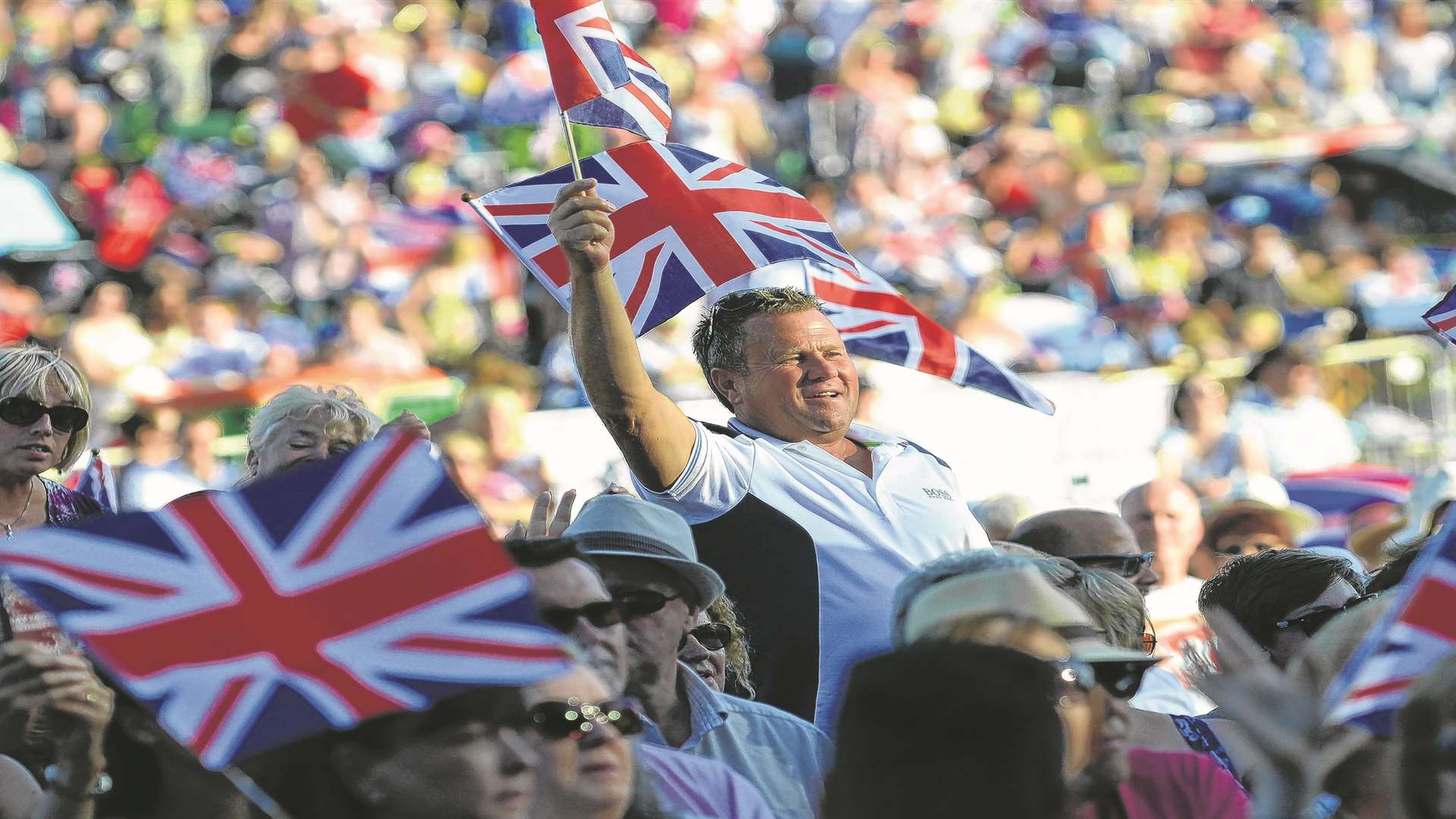 Spectators wave their Union flags at the Leeds Castle Classical Concert