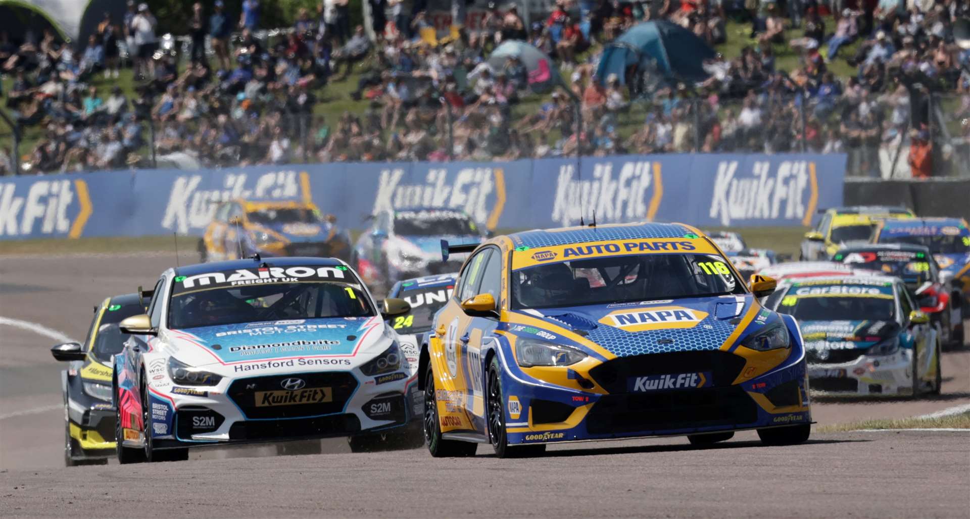 Motorbase Performance NAPA Racing's Ash Sutton, right, leads the field at Thruxton. Picture: BTCC/Jakob Ebrey