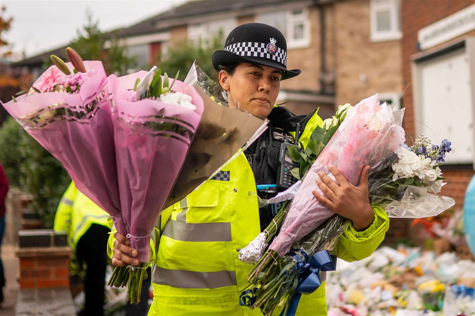 A police officer arranges flowers and tributes outside Belfairs Methodist Church (Aaron Chown/PA)