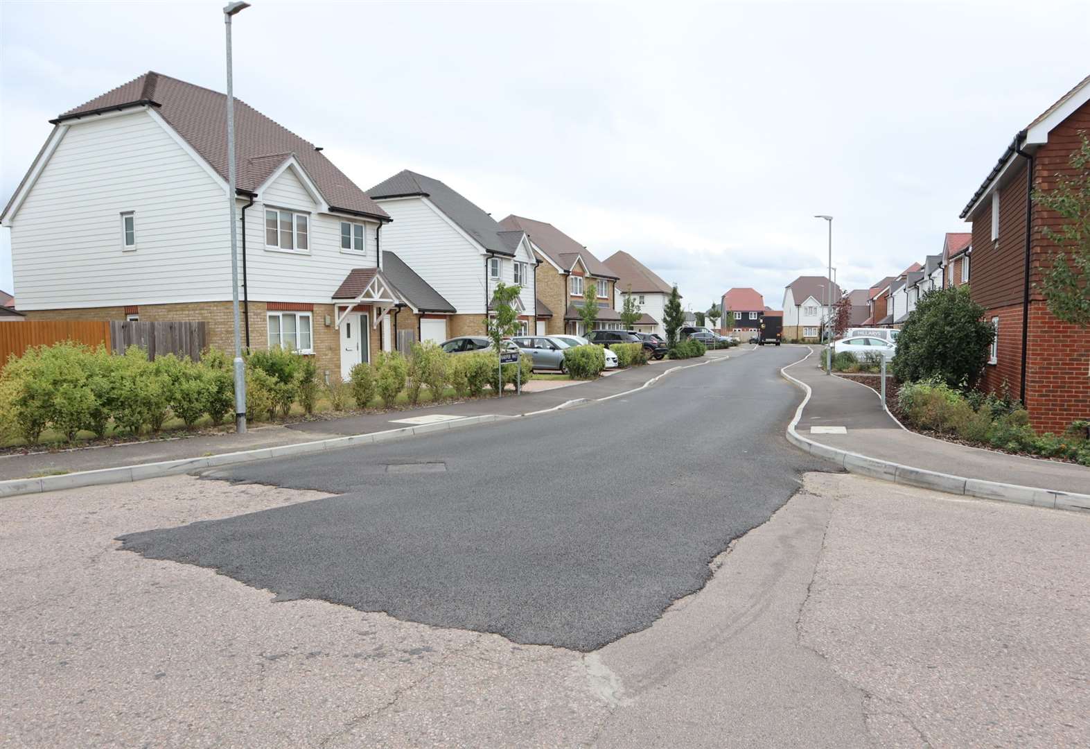 Patched road in Eveas Drive, Heron Fields, Great Easthall, Murston, Sittingbourne