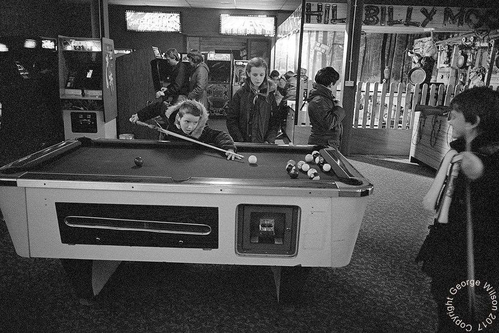 Playing pool in front of the Hillbilly Moonshine shooting range. Copyright: George Wilson