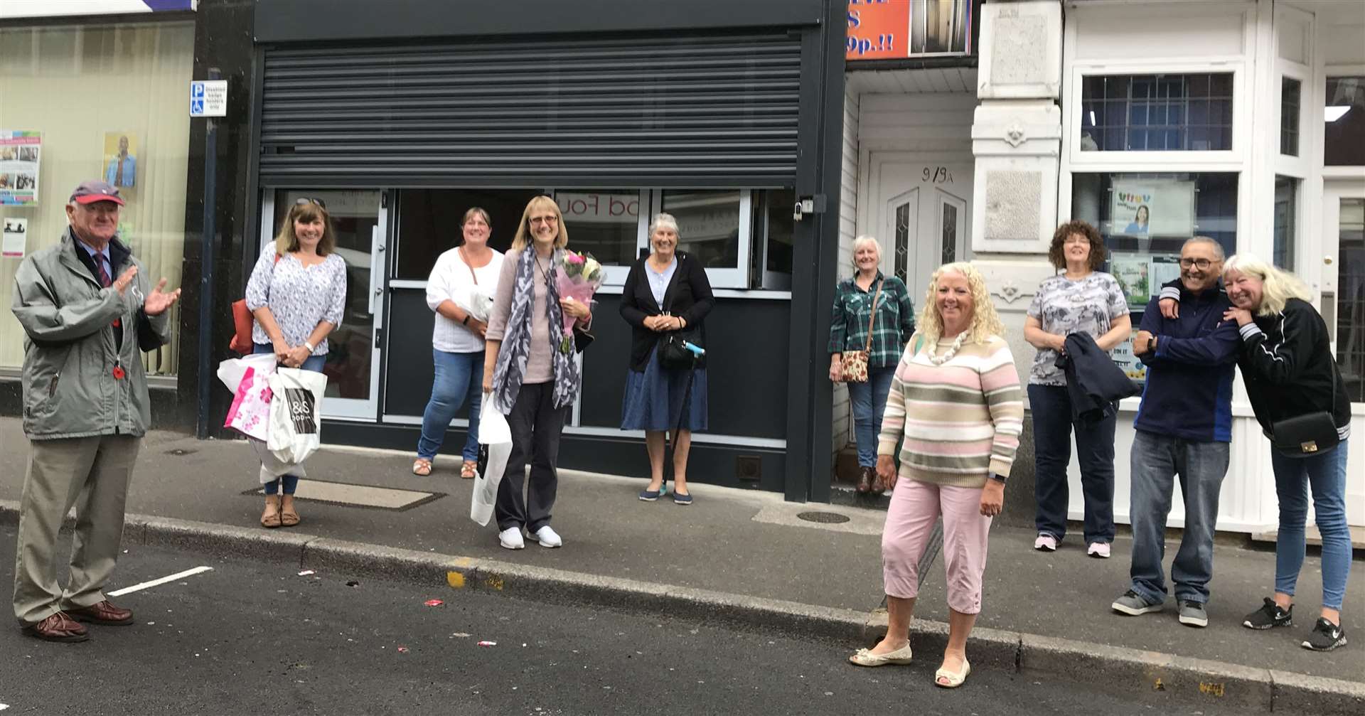 Ms Bromley, Mrs Pfeiffer and some of the volunteers outside the Mill Street office bidding the pair farewell on their final day