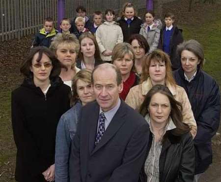 The children who are affected with parents and head teacher Ian Hobson. Picture: GRANT FALVEY
