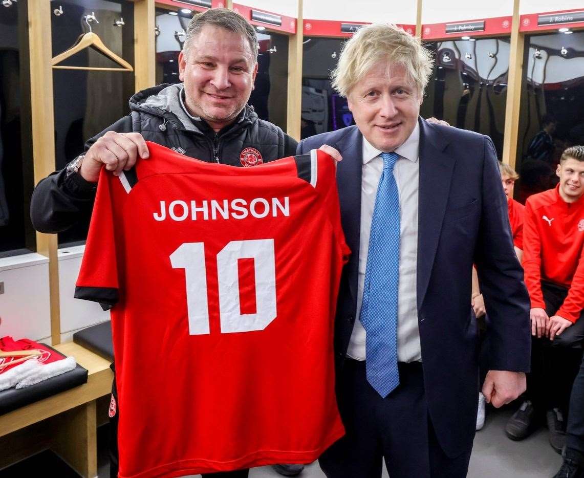 Boris Johnson paid Chatham Town a visit in February. The prime minister received an aptly-numbered shirt from chairman and manager Kevin Hake. Picture: CTFC