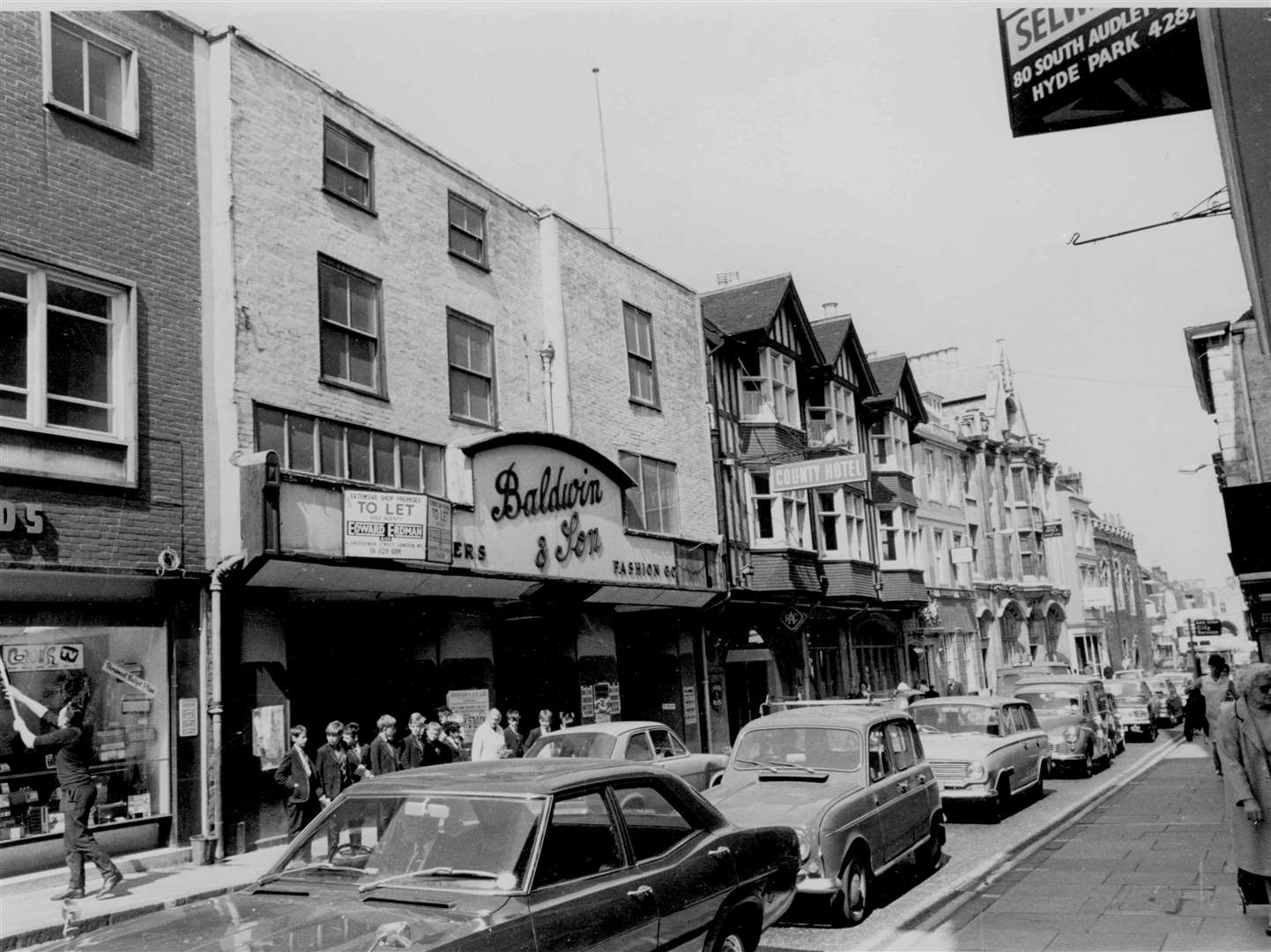 Traffic in Canterbury High Street passes the old Baldwin and Son store in August 1968
